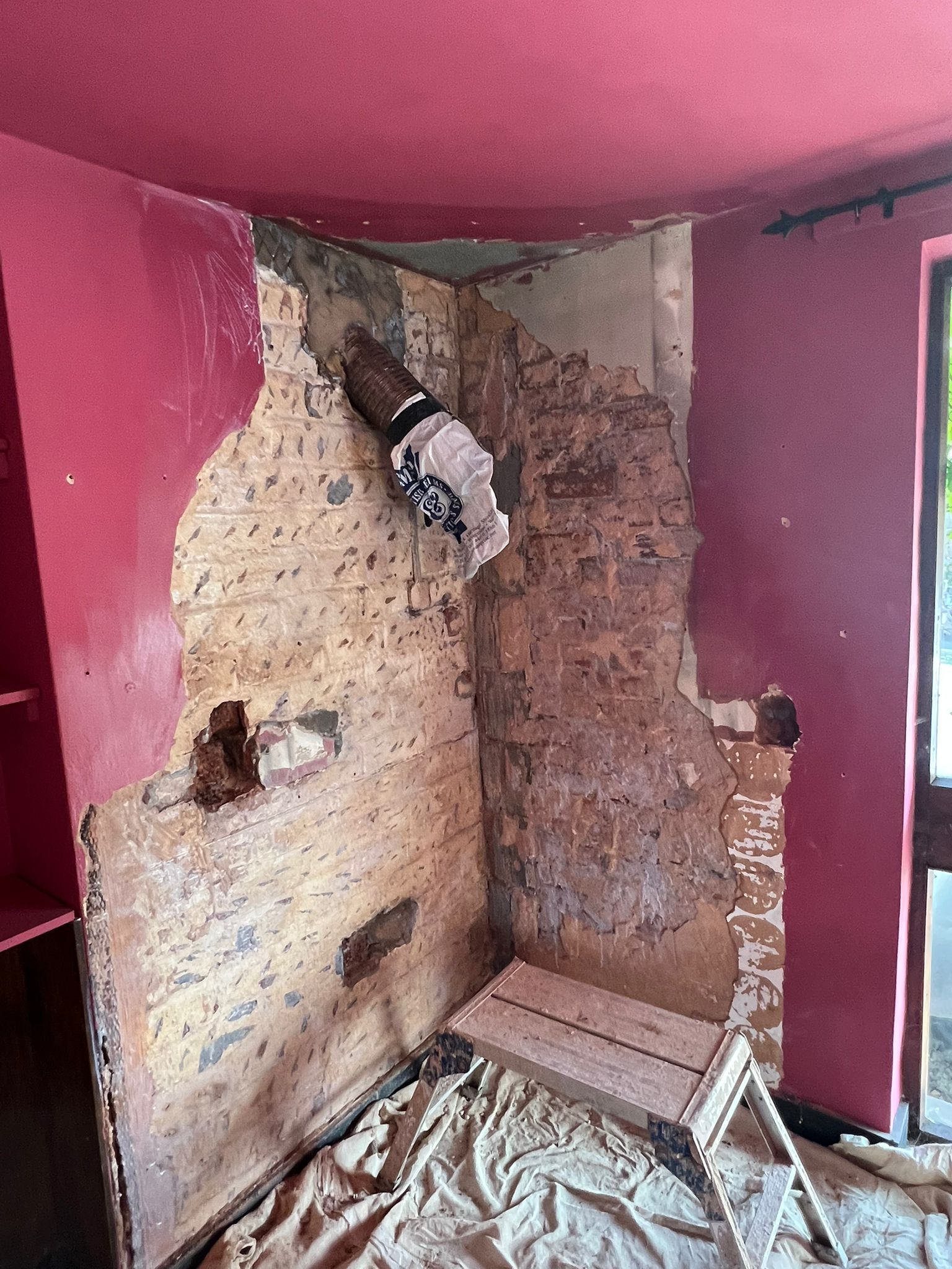 Chimney breast before plastering — exposed old plaster and brickwork