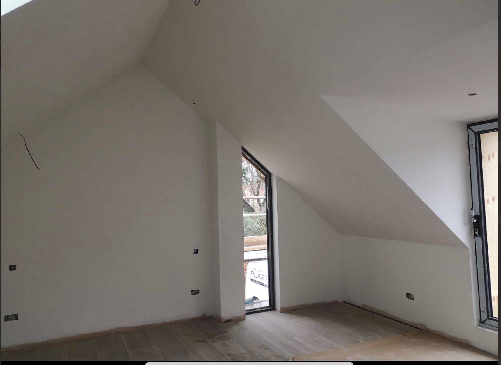 Finished plastered loft room with vaulted ceiling and modern windows