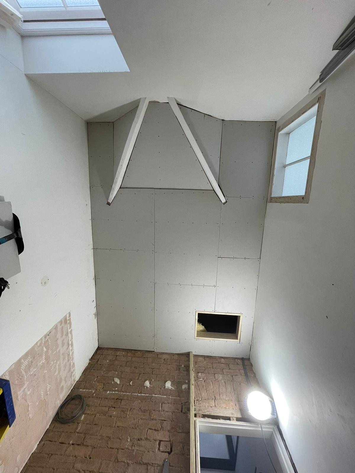 Loft conversion boarding with complex dormer angles and skylight