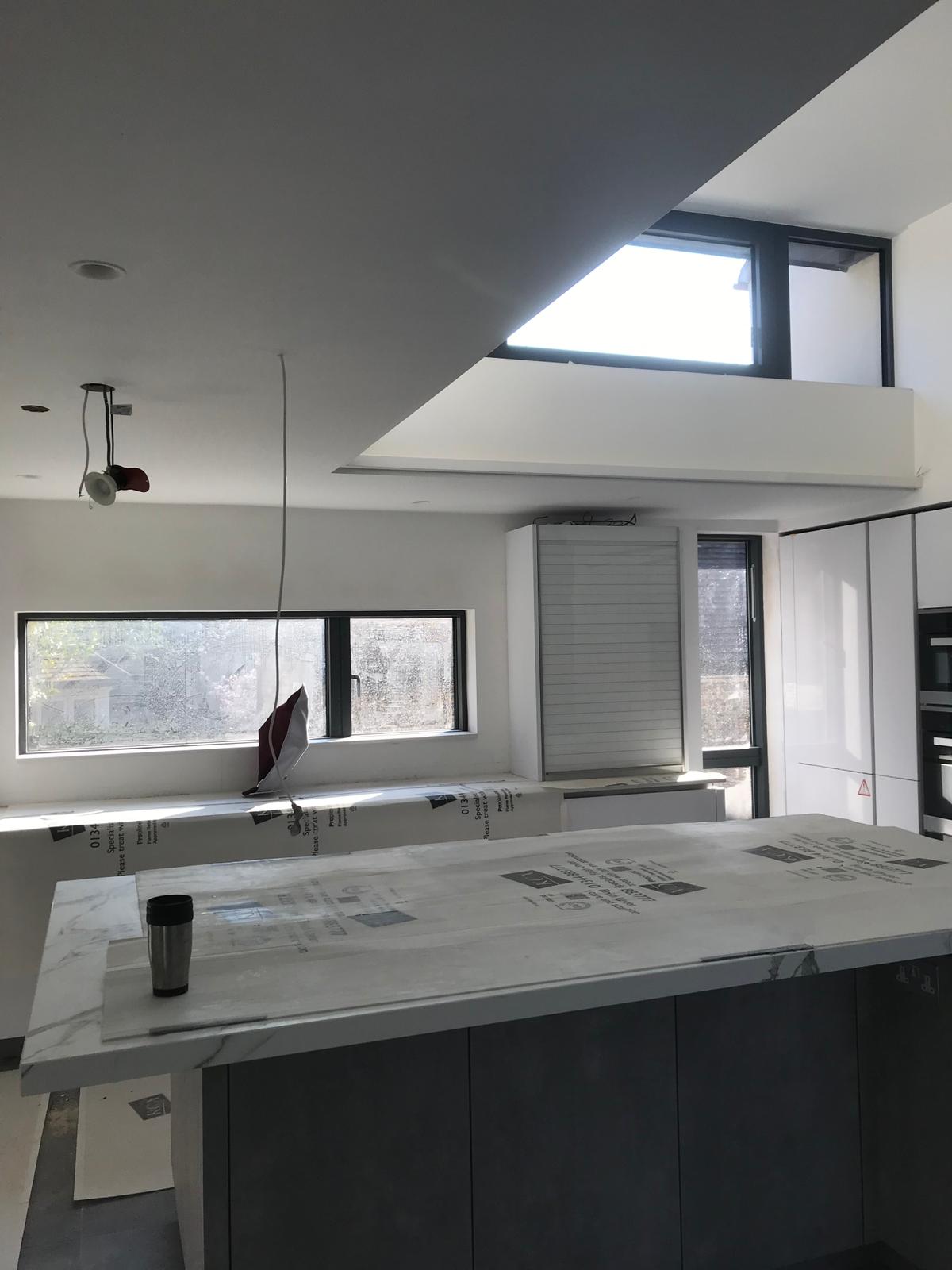 Modern kitchen with clerestory window and plastered ceiling